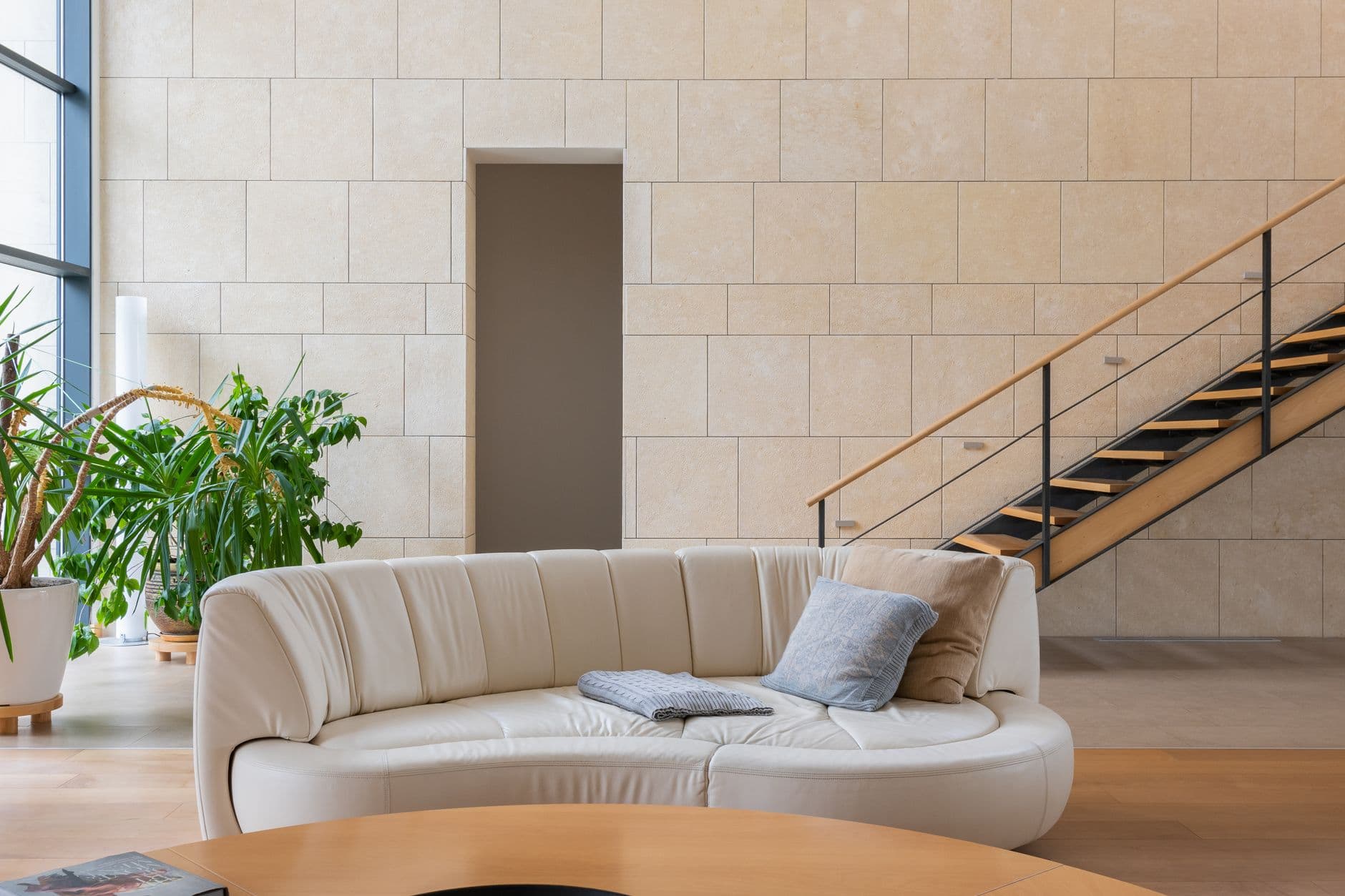 Warm studio reception with pale wood and stone